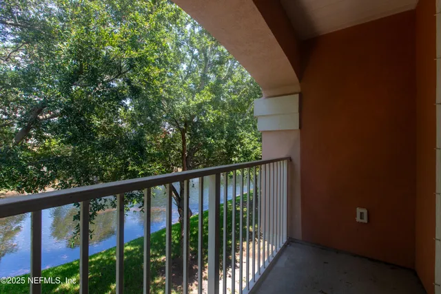 a view of a balcony with wooden floor