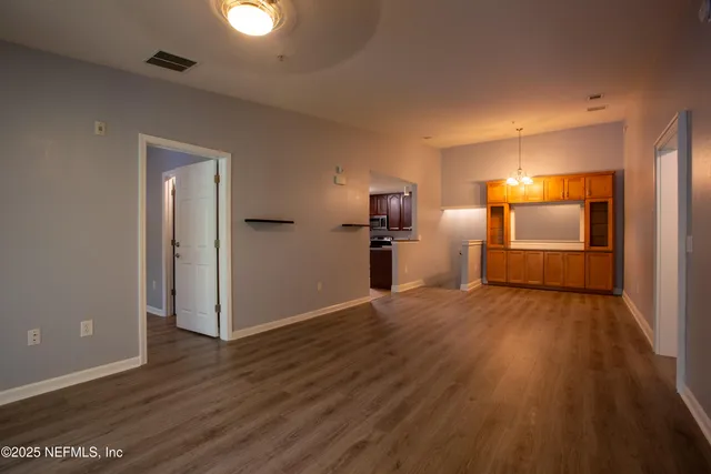 a view of a kitchen with a sink and a refrigerator