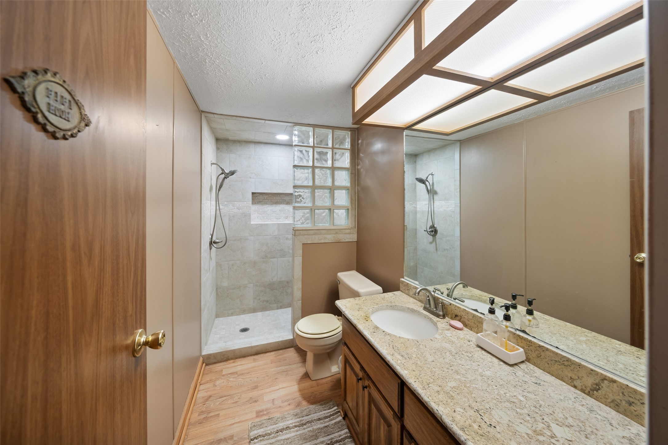 119 Fm 1891 Shiner, TX 77984 - Photo 12 of 40 a bathroom with a granite countertop sink a toilet and shower