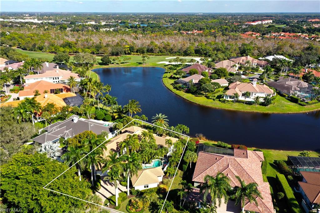 an aerial view of lake and residential houses with outdoor space