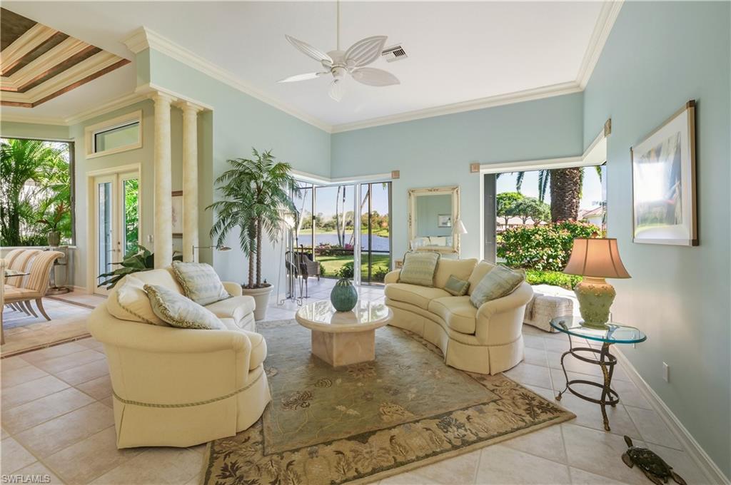 9264 Sweetgrass Way Naples, FL 34108 - Photo 13 of 40 a living room with furniture and a large window