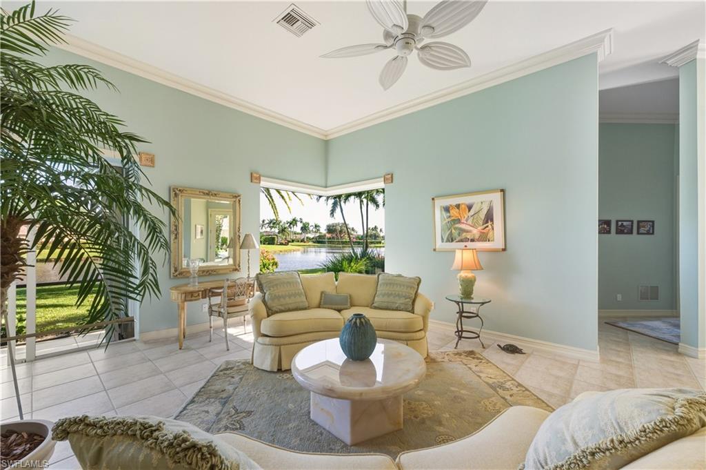 9264 Sweetgrass Way Naples, FL 34108 - Photo 17 of 40 a living room with furniture and a large window