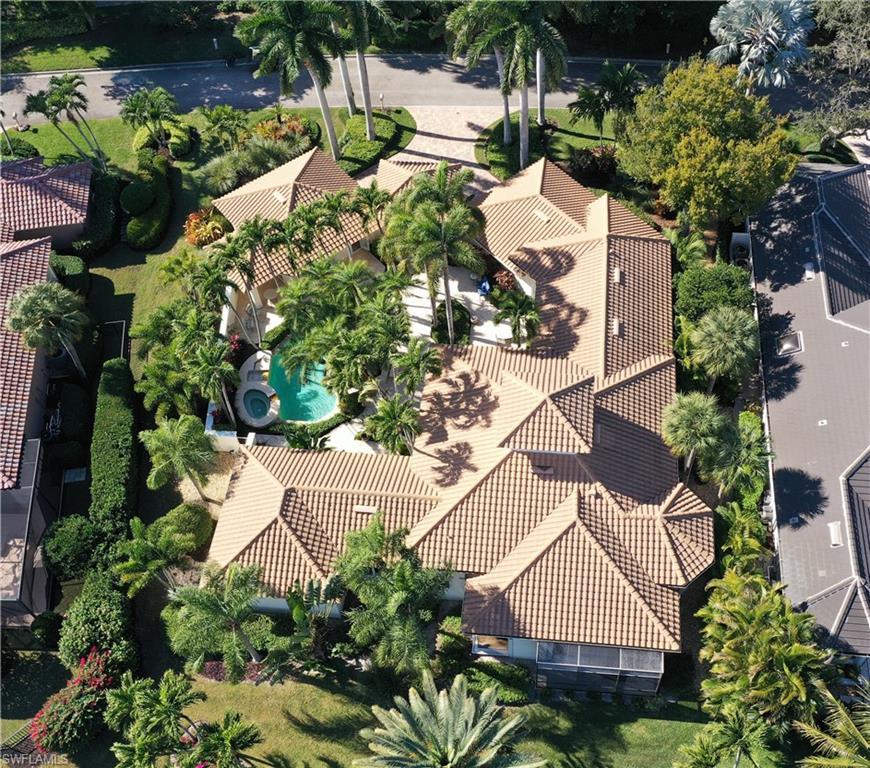 9264 Sweetgrass Way Naples, FL 34108 - Photo 2 of 40 an aerial view of a house with a yard and garden in the back