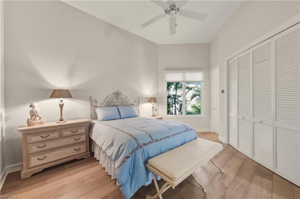 9264 Sweetgrass Way Naples, FL 34108 - Photo 26 of 40 a spacious bedroom with a bed and a dresser