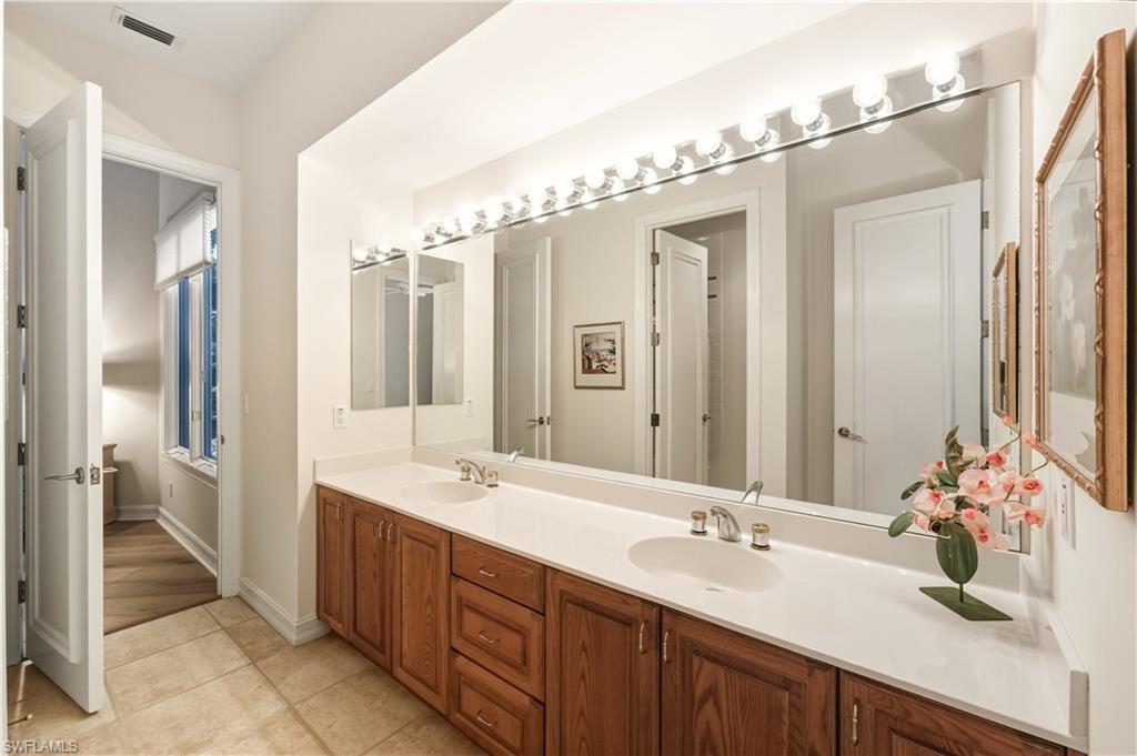 9264 Sweetgrass Way Naples, FL 34108 - Photo 27 of 40 a bathroom with a double vanity sink mirror and double