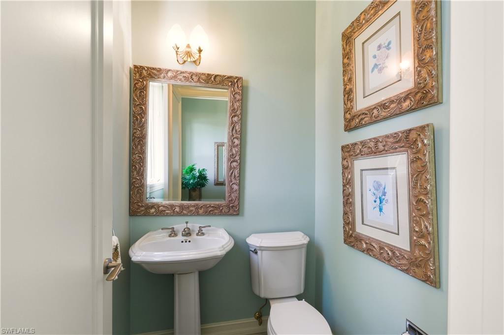 9264 Sweetgrass Way Naples, FL 34108 - Photo 29 of 40 a bathroom with a toilet a sink and a mirror