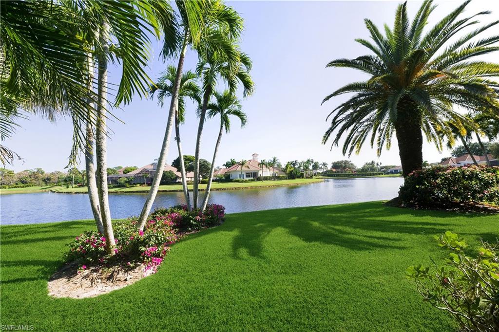 9264 Sweetgrass Way Naples, FL 34108 - Photo 32 of 40 a view of a lake and a garden