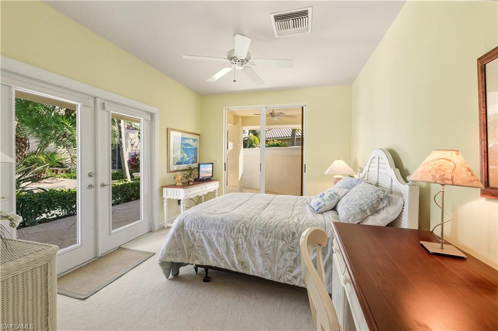 9264 Sweetgrass Way Naples, FL 34108 - Photo 35 of 40 a bedroom with a bed and large window