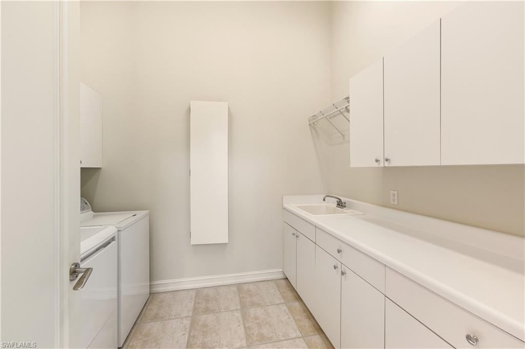 9264 Sweetgrass Way Naples, FL 34108 - Photo 37 of 40 a view of a kitchen with white cabinets