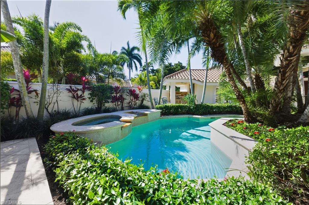 9264 Sweetgrass Way Naples, FL 34108 - Photo 39 of 40 a view of a house with swimming pool and garden