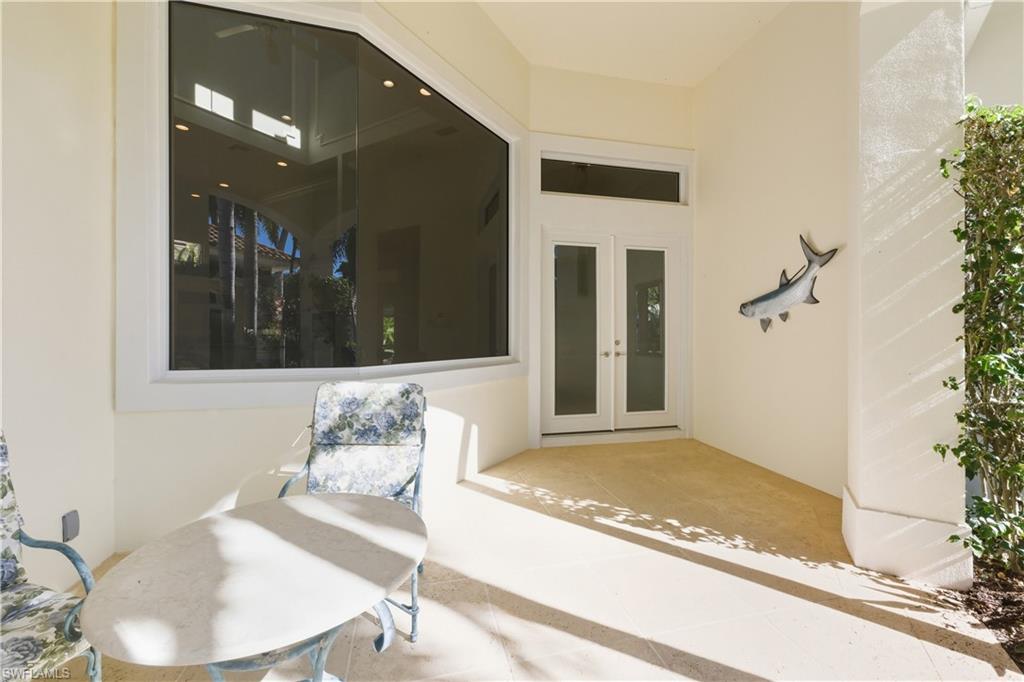 9264 Sweetgrass Way Naples, FL 34108 - Photo 4 of 40 a living room with furniture and a potted plant