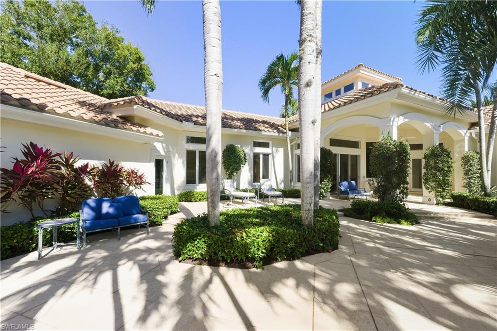9264 Sweetgrass Way Naples, FL 34108 - Photo 7 of 40 a view of a house with fountain and a garden