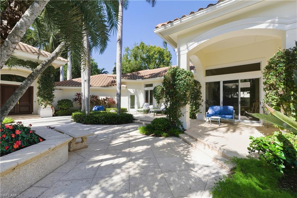 9264 Sweetgrass Way Naples, FL 34108 - Photo 10 of 40 a view of a house with backyard sitting area and garden