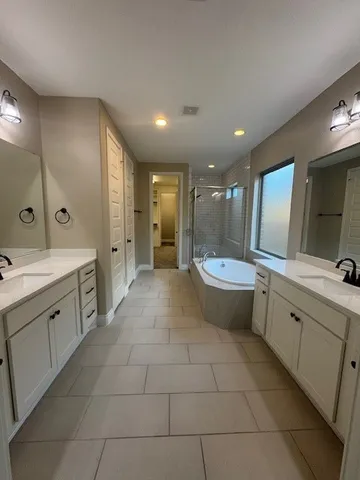 a view of an empty room with wooden floor and cabinet