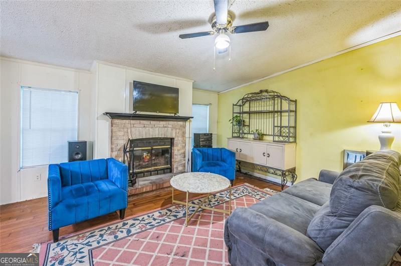 473 Haley Road Jackson, GA 30233 - Photo 12 of 13 a living room with furniture and a fireplace