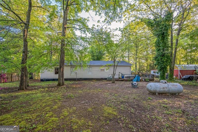 473 Haley Road Jackson, GA 30233 - Photo 2 of 13 a backyard of a house with oven and a tree