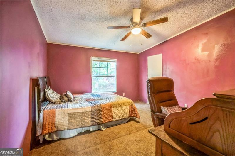 473 Haley Road Jackson, GA 30233 - Photo 3 of 13 a bedroom with two beds and ceiling fan