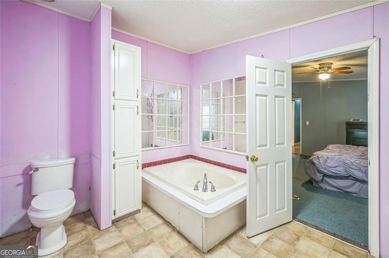 473 Haley Road Jackson, GA 30233 - Photo 5 of 13 a bathroom with a tub sink and toilet