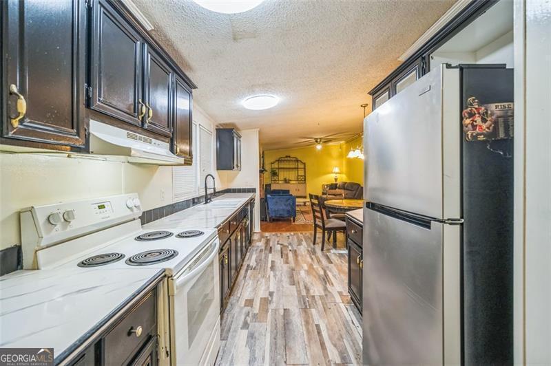 473 Haley Road Jackson, GA 30233 - Photo 9 of 13 a kitchen with a refrigerator a stove and wooden floor