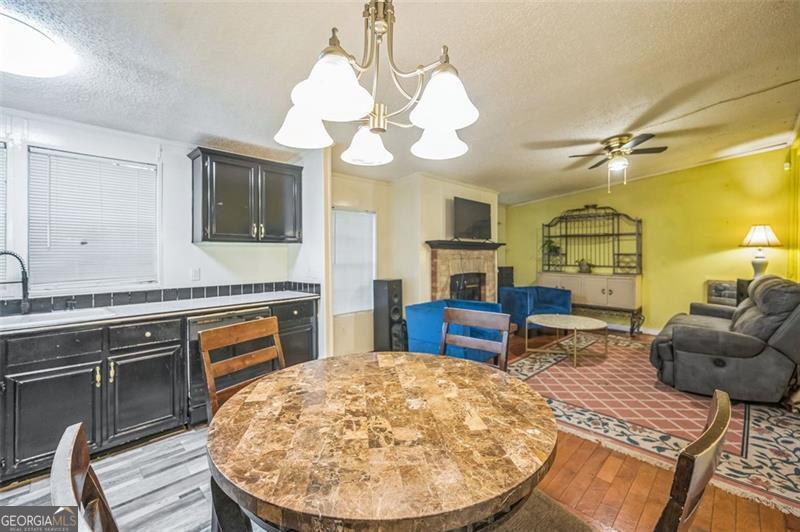 473 Haley Road Jackson, GA 30233 - Photo 10 of 13 a living room with furniture a fireplace and a chandelier