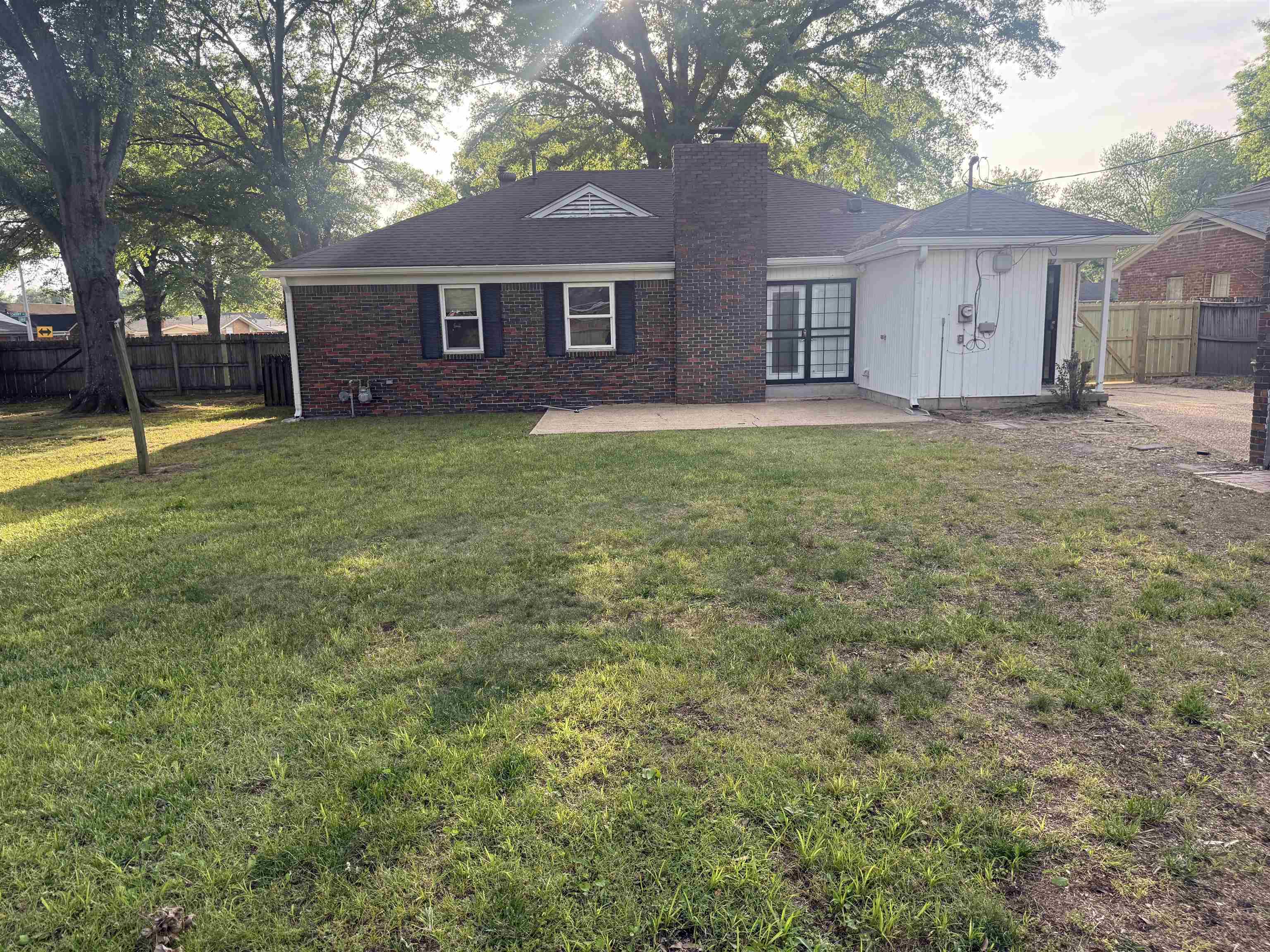1918 Cherry Road Memphis, TN 38117 - Photo 25 of 26 Expansive backyard featuring a brick exterior, patio space, and mature trees