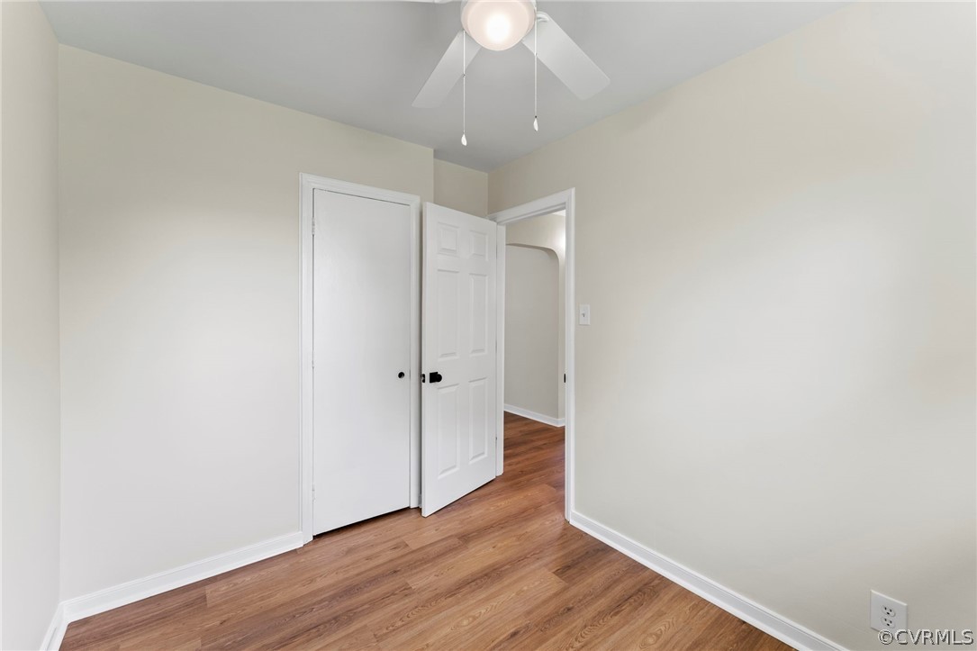3319 Croydon Road Richmond, VA 23223 - Photo 16 of 22 a view of an empty room with wooden floor and a ceiling fan