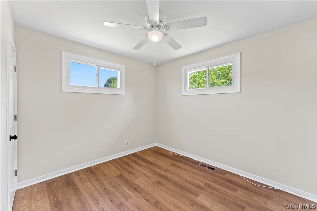 3319 Croydon Road Richmond, VA 23223 - Photo 17 of 22 an empty room with a window and a ceiling fan
