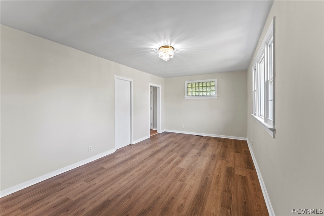 3319 Croydon Road Richmond, VA 23223 - Photo 4 of 22 wooden floor in an empty room with a window