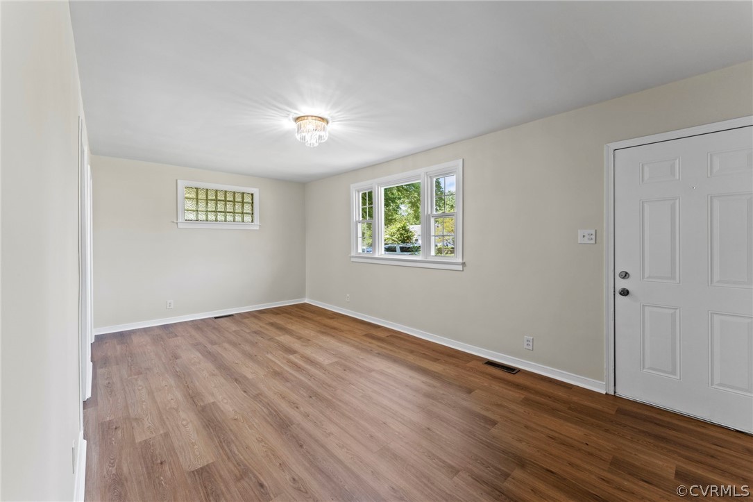 3319 Croydon Road Richmond, VA 23223 - Photo 5 of 22 an empty room with wooden floor and windows