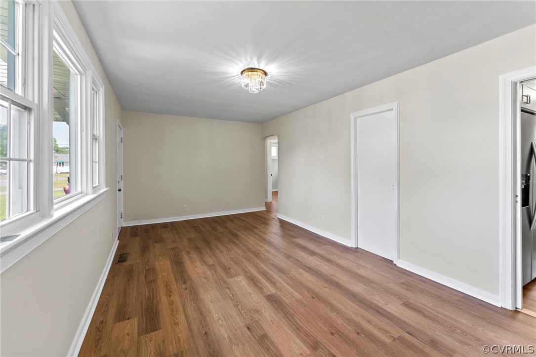 3319 Croydon Road Richmond, VA 23223 - Photo 6 of 22 a view of an empty room with wooden floor and a window
