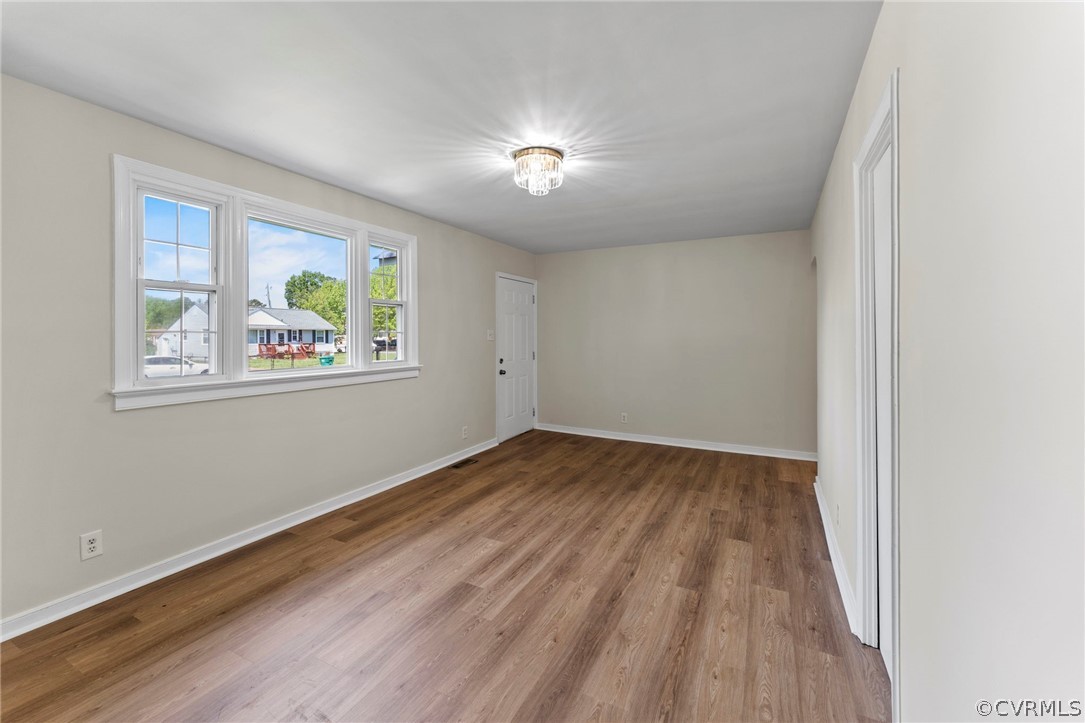 3319 Croydon Road Richmond, VA 23223 - Photo 7 of 22 an empty room with wooden floor and windows