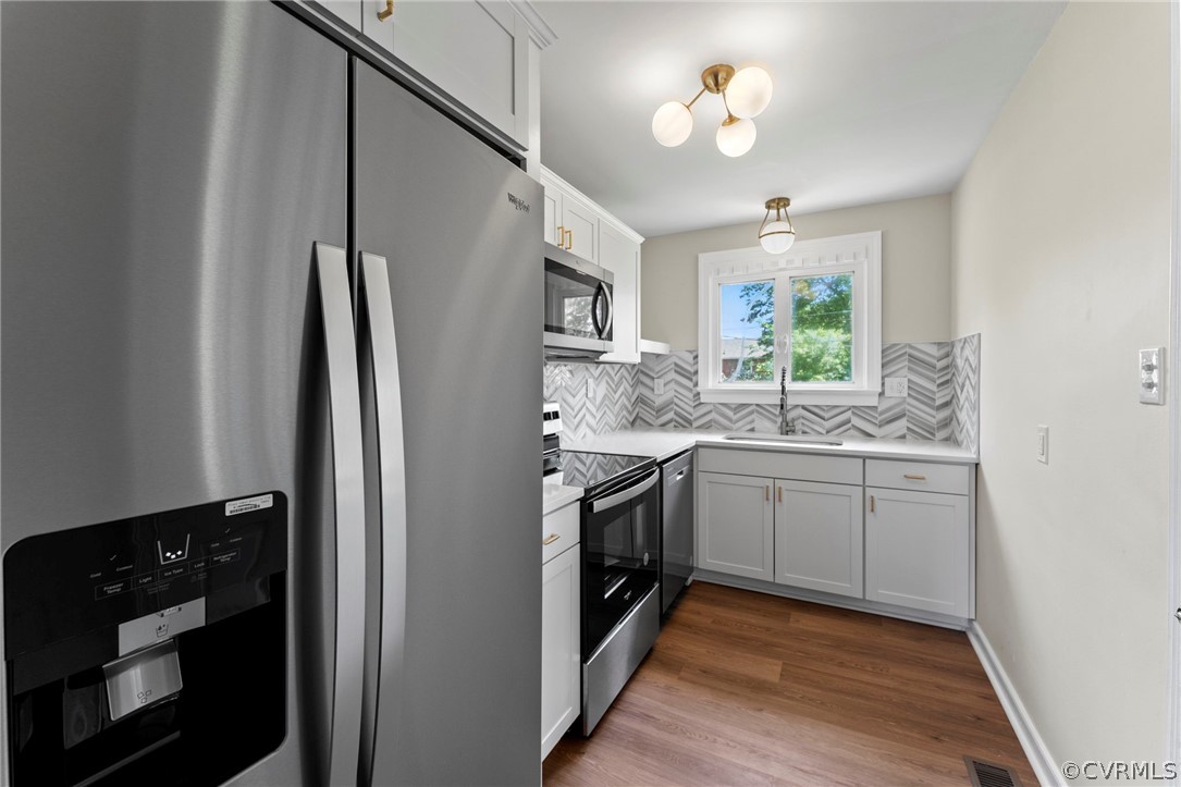 3319 Croydon Road Richmond, VA 23223 - Photo 8 of 22 a kitchen with stainless steel appliances granite countertop a refrigerator a stove a sink and a window