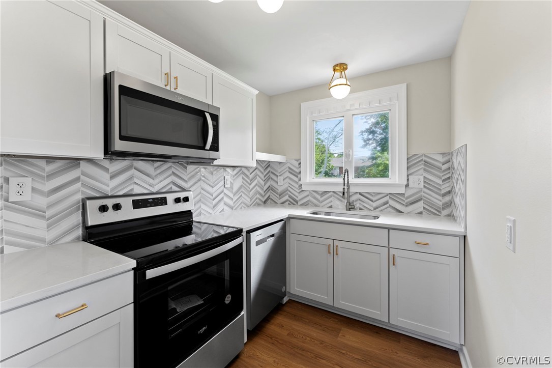 3319 Croydon Road Richmond, VA 23223 - Photo 9 of 22 a kitchen with stainless steel appliances a stove microwave and sink