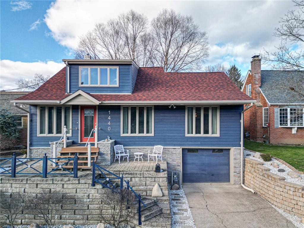 a front view of a house with a garden and patio