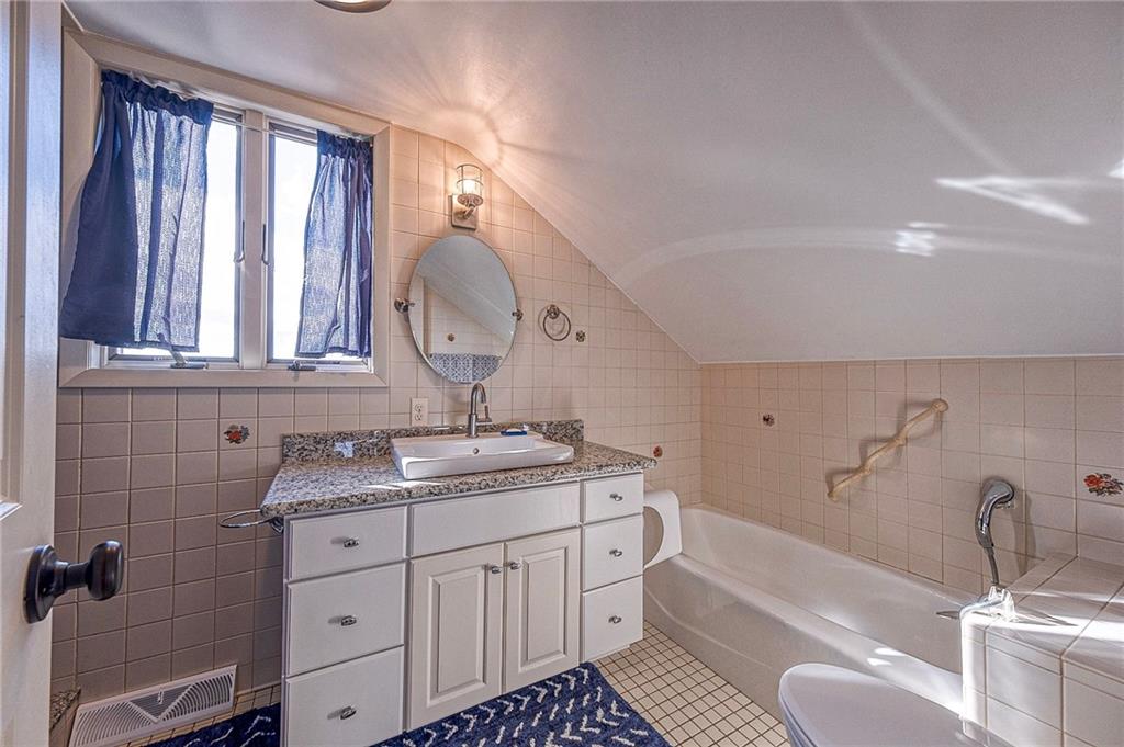 1440 Ohio Street Beaver, PA 15009 - Photo 22 of 36 a bathroom with a granite countertop sink and a bathtub