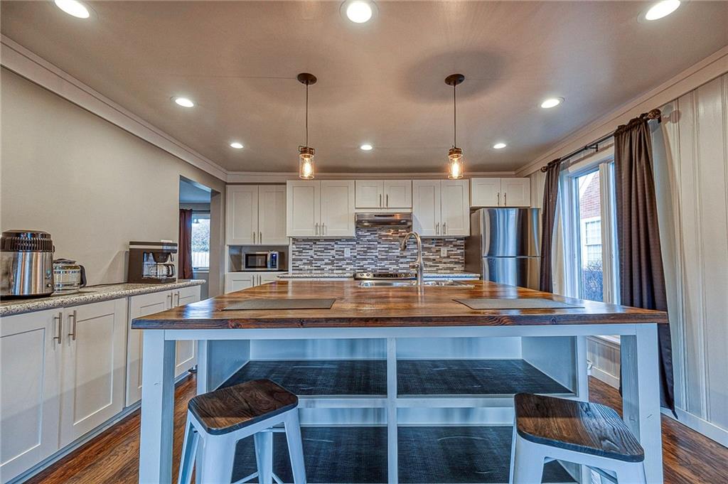 1440 Ohio Street Beaver, PA 15009 - Photo 10 of 36 a kitchen with kitchen island white cabinets and stainless steel appliances