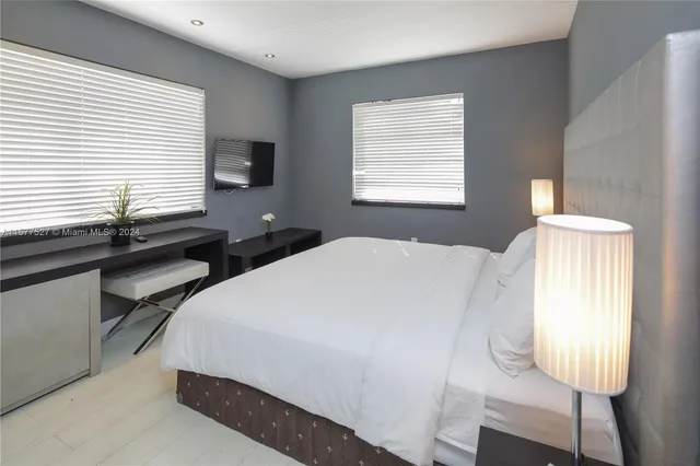 a bedroom with double bed and a window