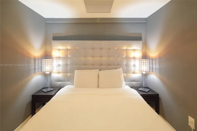 a kitchen with a refrigerator and a wooden floor