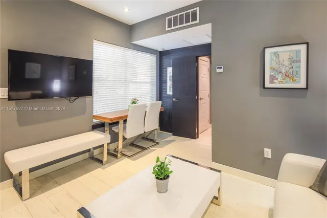 a dining room with furniture and window