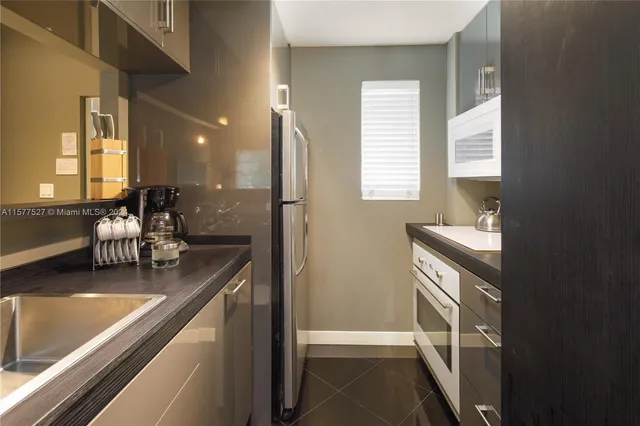 a kitchen with a sink cabinets and window
