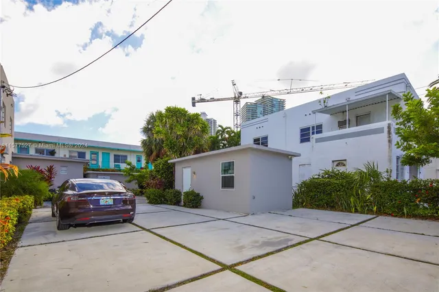 a view of a house with potted plants