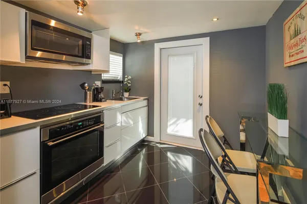 a kitchen with a sink appliances and cabinets