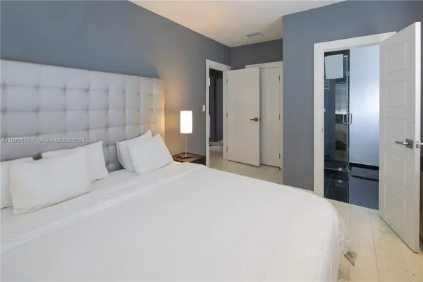 a bedroom with a bed and a dresser
