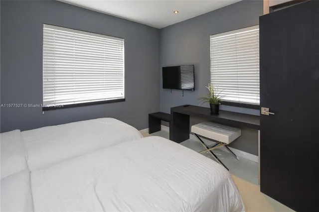 a bedroom with two beds and a window