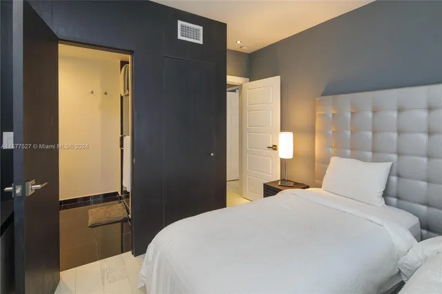 a bedroom with a bed and closet