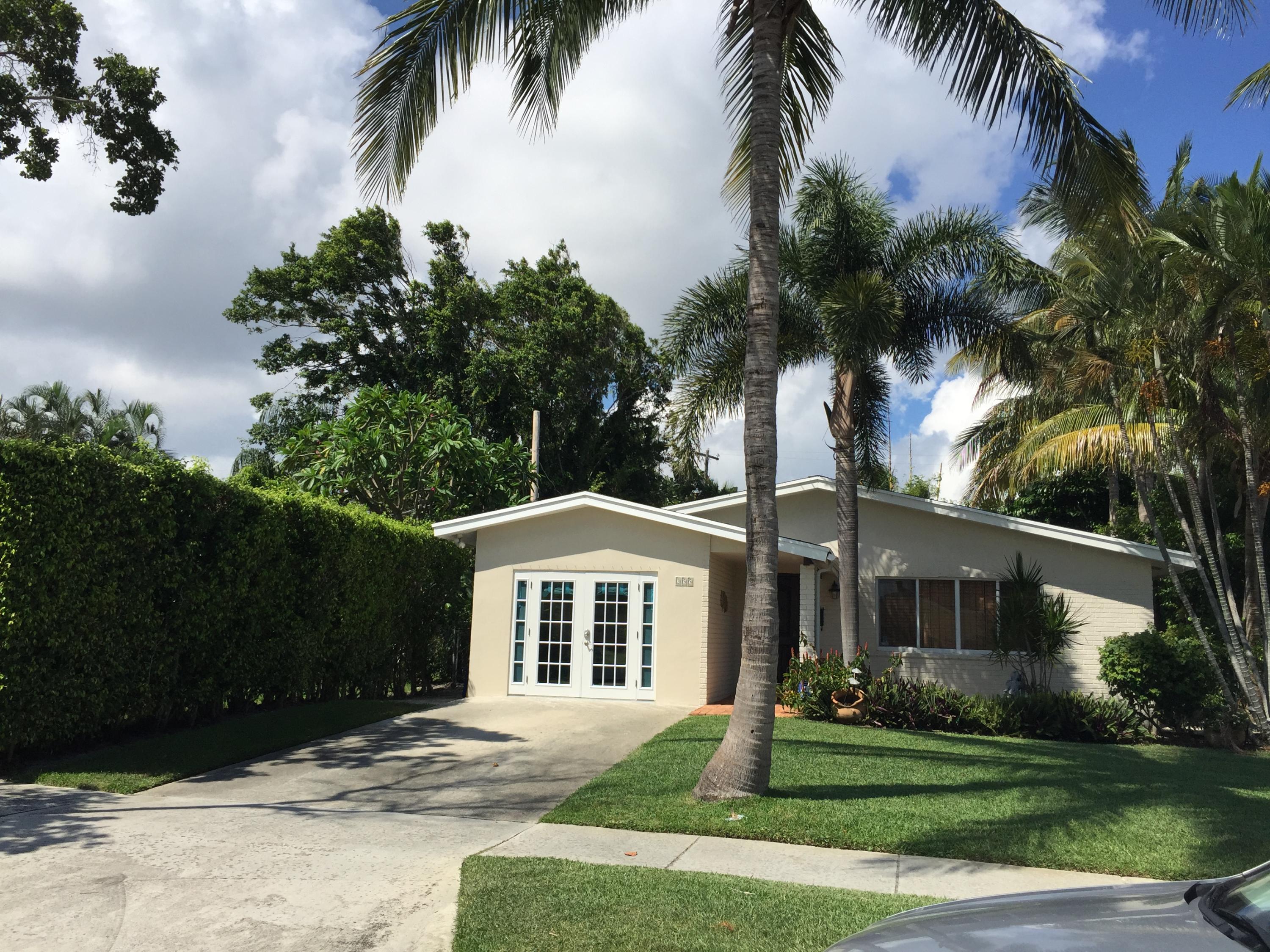 255 Cortez Road West Palm Beach, FL 33405 - Photo 1 of 26 a front view of a house with a yard and garage