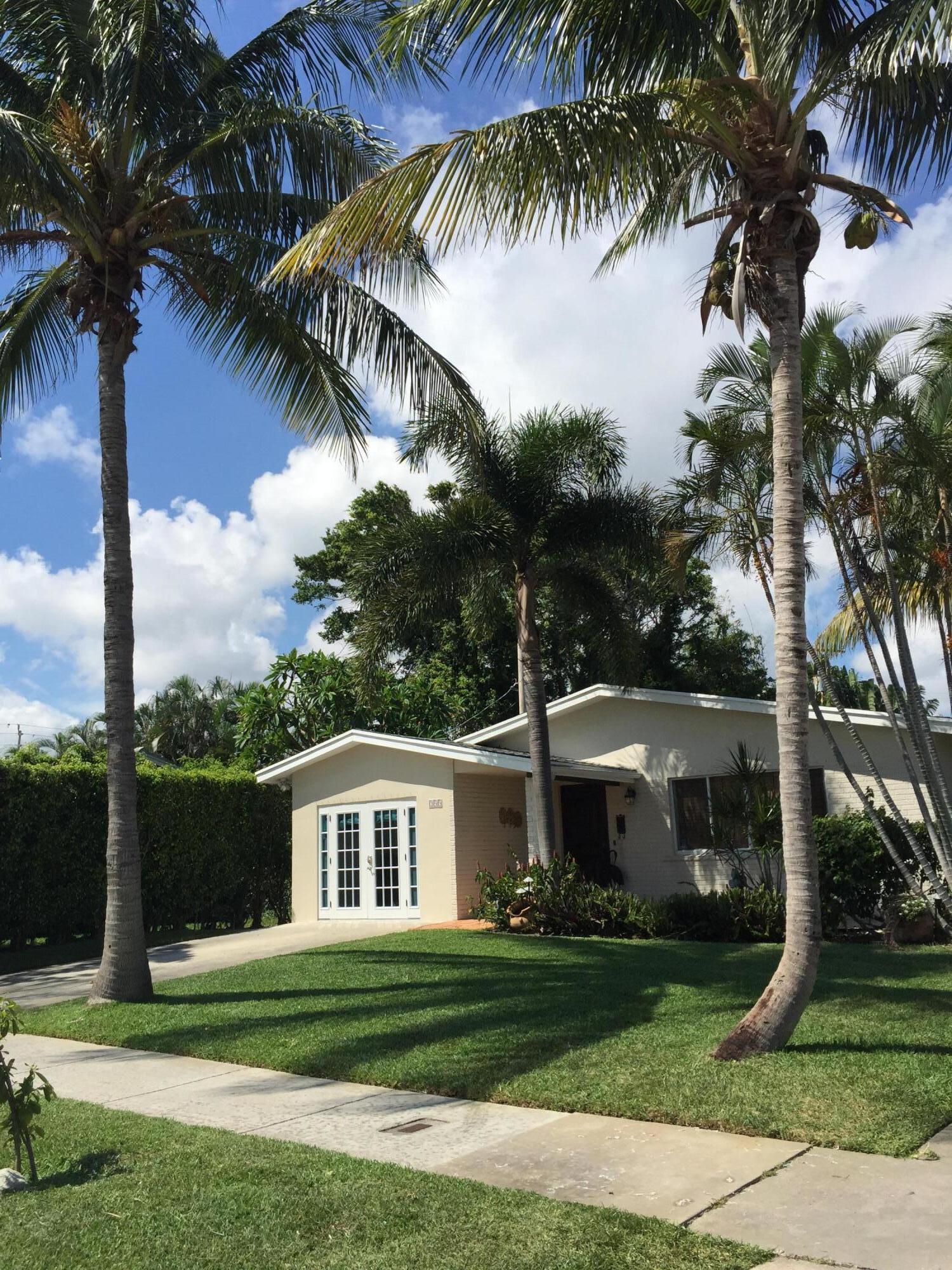 255 Cortez Road West Palm Beach, FL 33405 - Photo 2 of 26 a front view of a house with garden