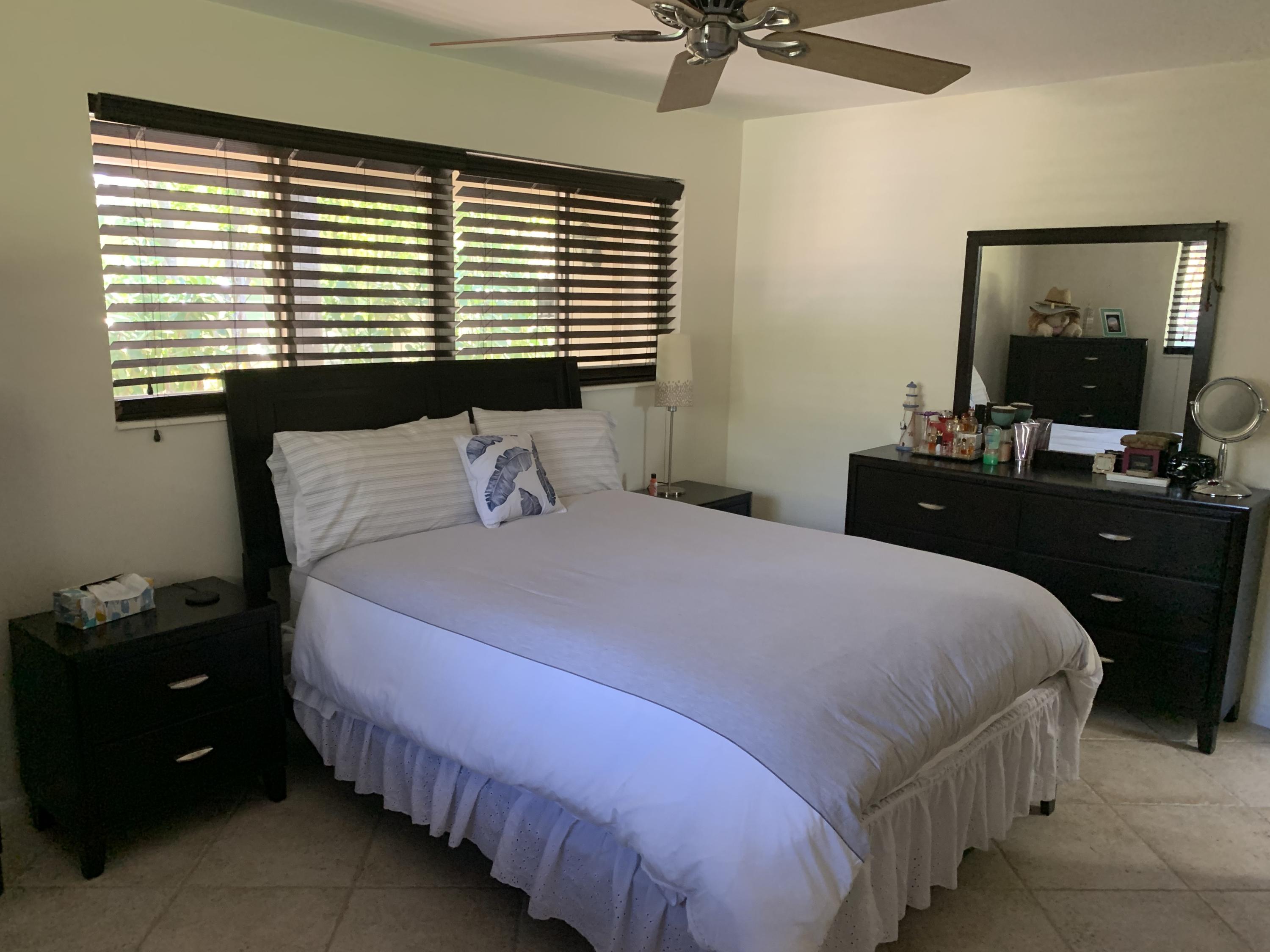 255 Cortez Road West Palm Beach, FL 33405 - Photo 14 of 26 a bedroom with a bed and a mirror