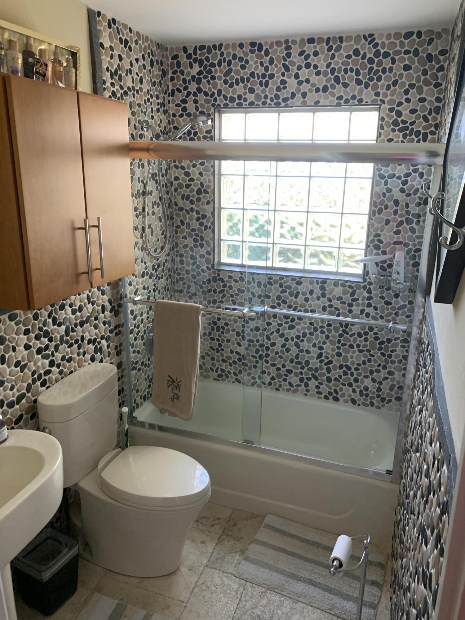 255 Cortez Road West Palm Beach, FL 33405 - Photo 19 of 26 a bathroom with a toilet a sink and a shower