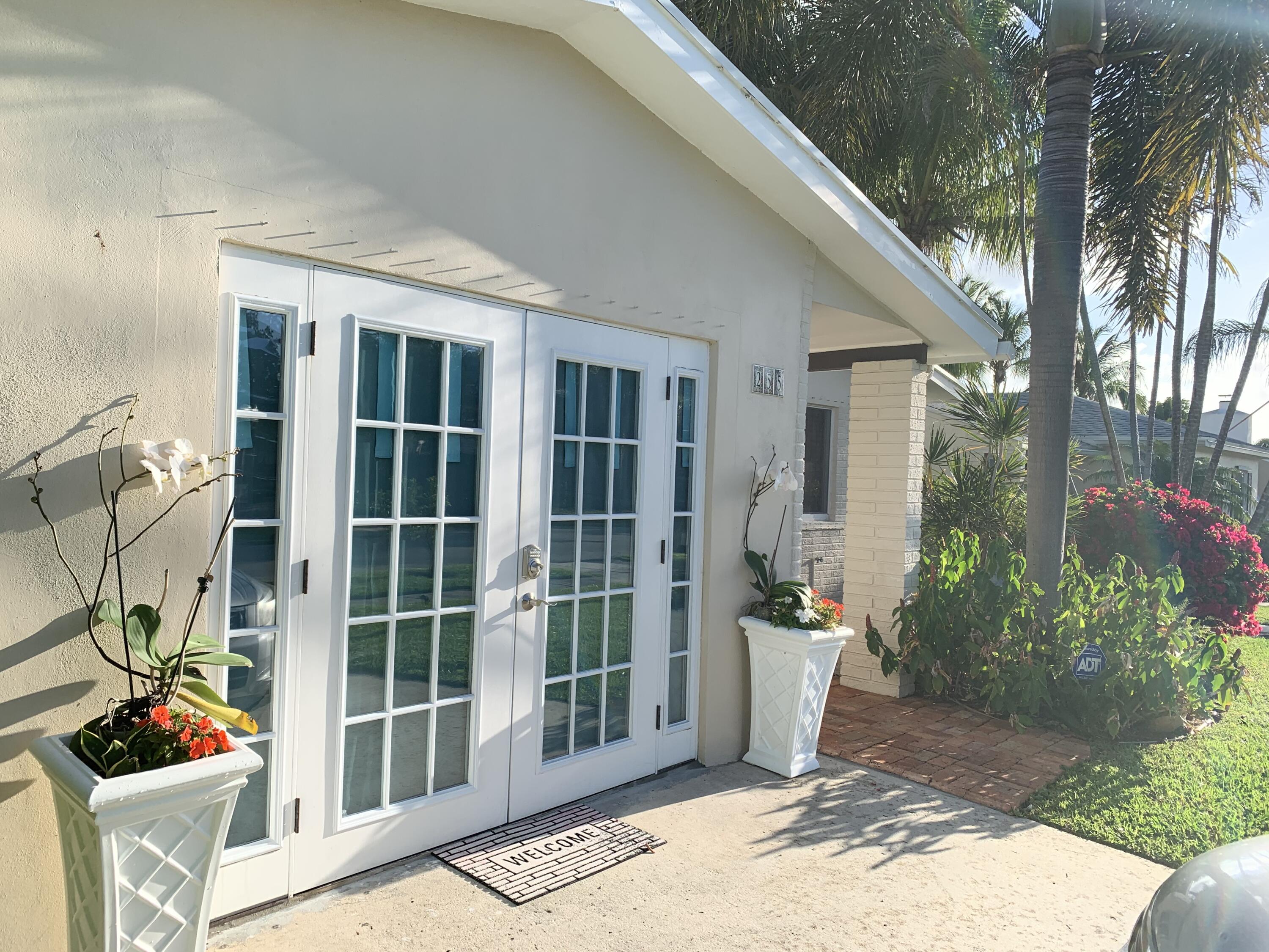255 Cortez Road West Palm Beach, FL 33405 - Photo 3 of 26 a front view of a house with a porch